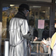 A New Black Panther Party Member stands outside a polling place. (demotix.com)